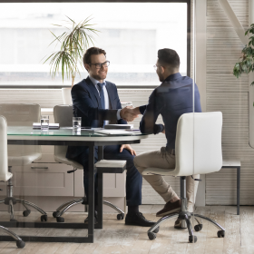 Two business men coming to an agreement through IBISWorld data